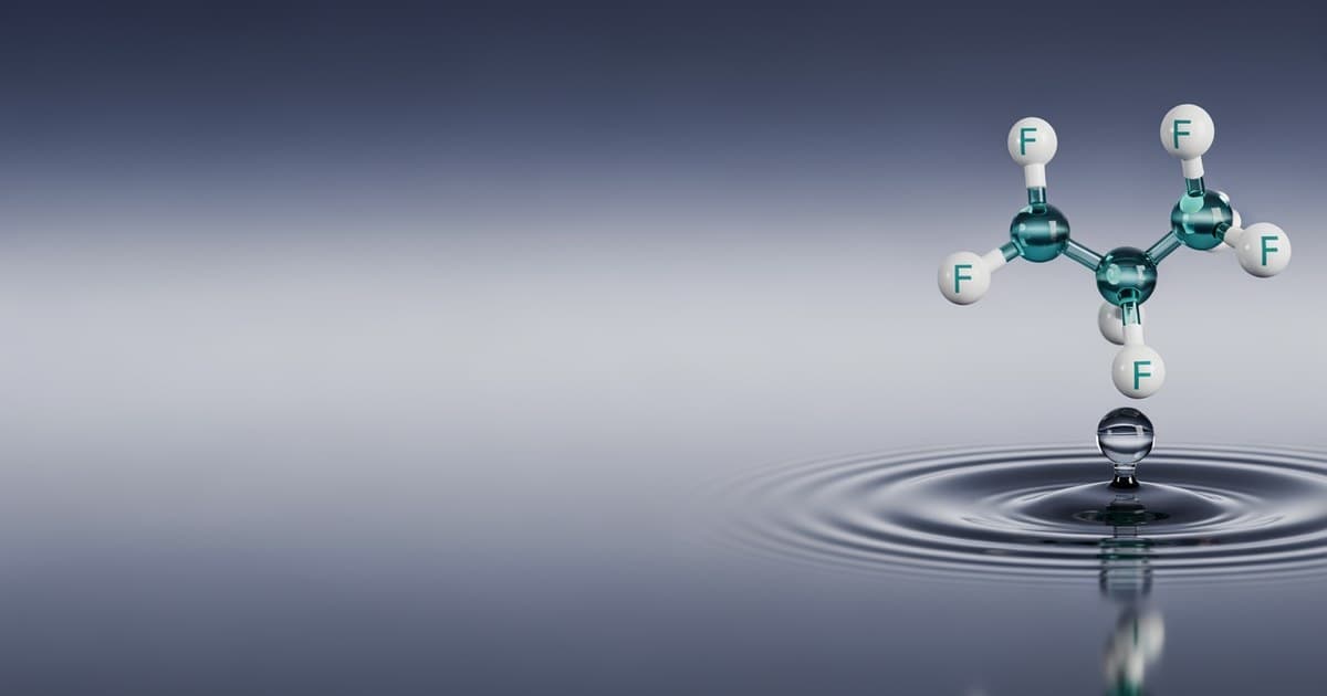 A perfluorinated compound molecule suspended over a water droplet, representing PFAS exposure and reproductive health